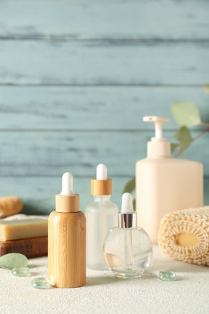 Cosmetic dropper bottles on color backgroundの写真素材