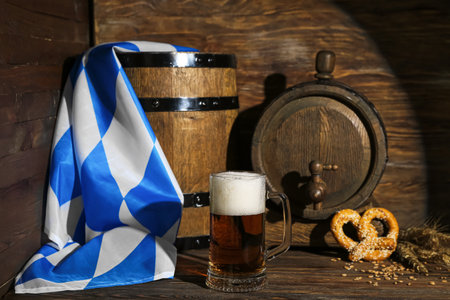 Mug of cold beer and barrels on wooden background. celebrationの写真素材