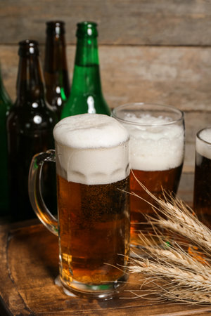 Mug of cold beer on wooden background. celebrationの写真素材