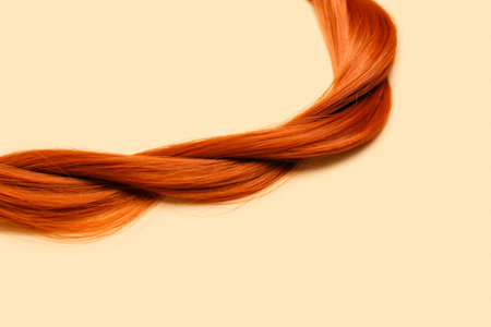 Braided ginger hair on color backgroundの写真素材