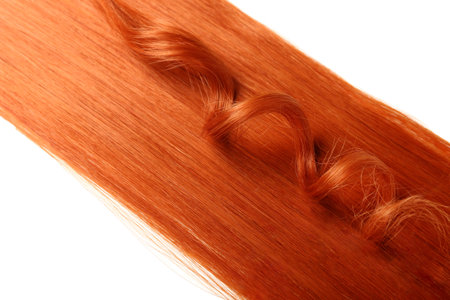 Ginger hair with curly strand on white background, closeupの写真素材