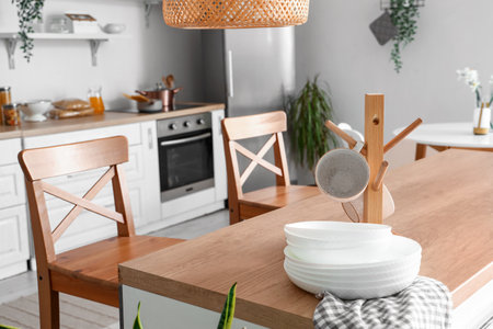 Interior of light kitchen with stylish fridge, counters, chairs and utensils, closeupの写真素材