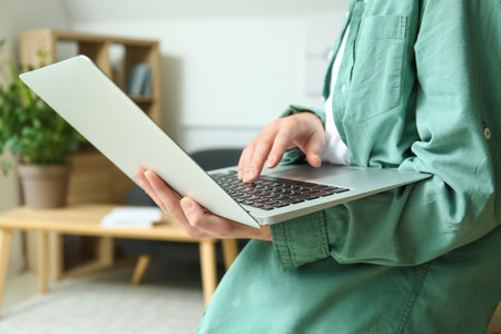 Male freelancer working with laptop in office, closeupの写真素材