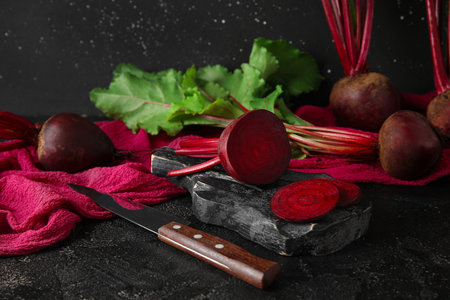 wooden board with fresh beets on table