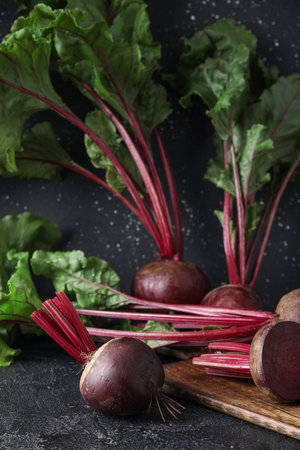 wooden board with fresh beets on table
