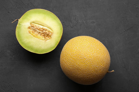 Sweet melon with half on black backgroundの写真素材