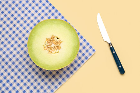 Half of sweet melon on yellow backgroundの写真素材