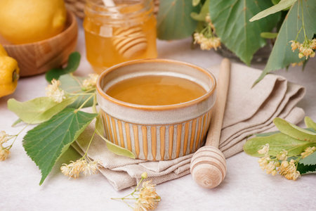 Bowl and jar with linden honey on white backgroundの写真素材