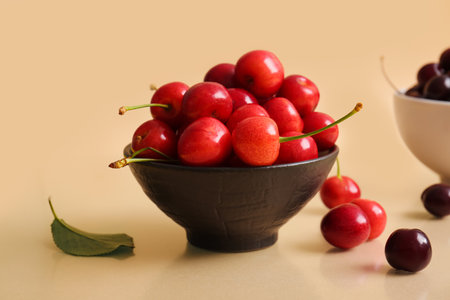 Bowl sweet cherry on beige backgroundの写真素材