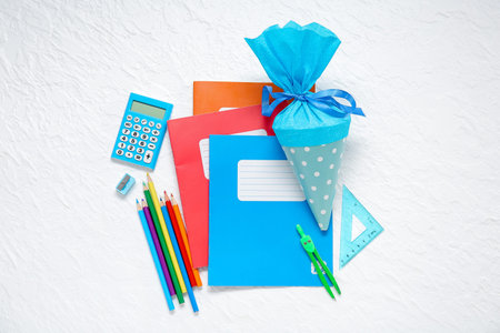 Blue school cone with different stationery on white background