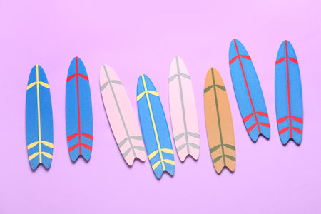 Many different colorful mini surfboards on lilac backgroundの写真素材
