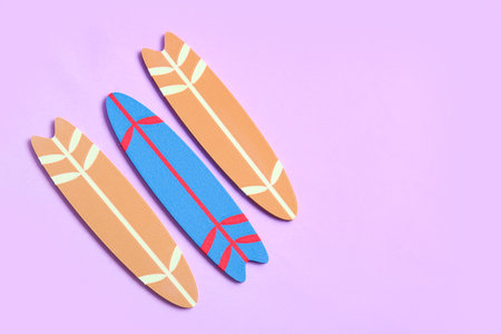 Different mini surfboards on lilac backgroundの写真素材