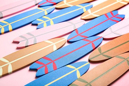 Many different colorful mini surfboards on pink backgroundの写真素材