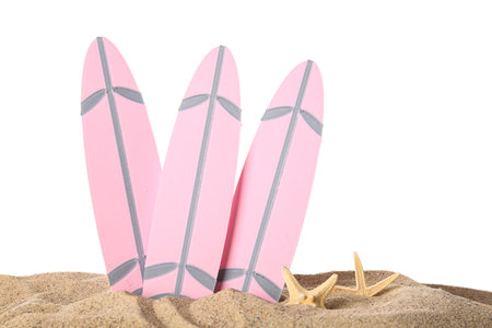 Mini surfboards with starfishes on sand against white backgroundの写真素材