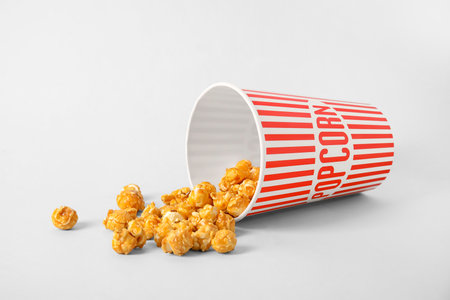 Bucket with tasty popcorn on gray backgroundの写真素材