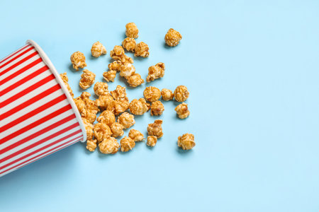 Bucket with tasty popcorn on blue backgroundの写真素材