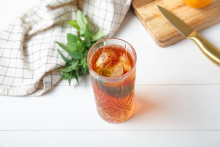 Glass of ice tea with mint on white wooden backgroundの写真素材