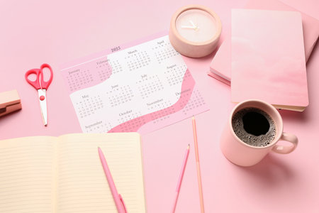 Composition with calendar, cup of coffee, alarm clock and stationary on pink backgroundの写真素材