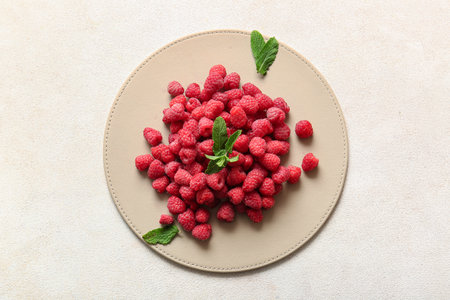 Heap of fresh raspberries and mint on white backgroundの写真素材