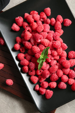 Plate with fresh raspberries and mint, closeupの写真素材