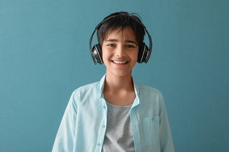 Little boy in headphones on blue background