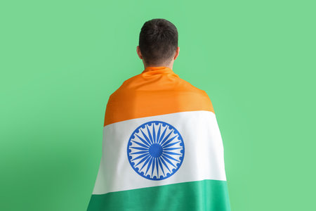 Young man with Indian flag on green background, back viewの写真素材