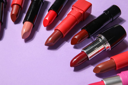 Frame made of different lipsticks on lilac background, closeupの写真素材