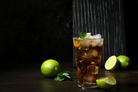 Glass of tasty Cuba Libre cocktail on tableの写真素材