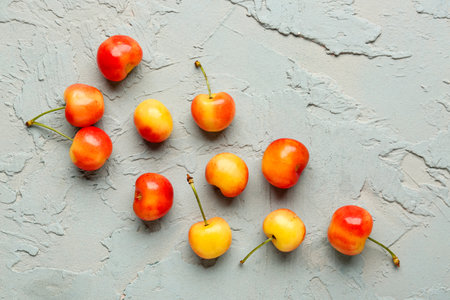 Sweet yellow cherry on blue backgroundの写真素材