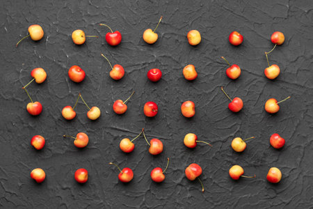 Many sweet yellow cherries on black backgroundの写真素材