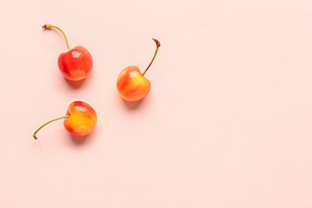 Sweet yellow cherry on pink backgroundの写真素材