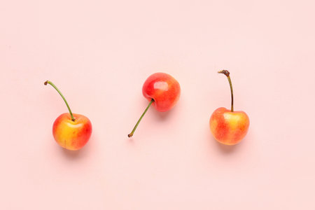 Sweet yellow cherry on pink backgroundの写真素材