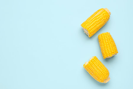 Cut fresh corn cobs on blue backgroundの写真素材