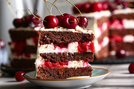 Plate with piece of tasty cherry cake on table, closeupの写真素材