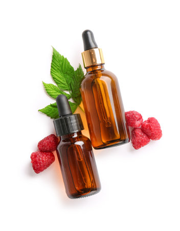 Bottles of cosmetic raspberry oil on white backgroundの写真素材