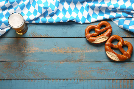 Flag of Bavaria, mug with beer and pretzels on blue wooden backgroundの写真素材
