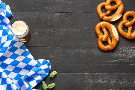 Flag of Bavaria, mug with beer and pretzels on black wooden backgroundの写真素材