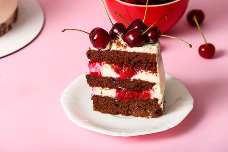Plate with piece of tasty cherry cake on pink background