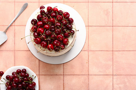 Tasty cherry cake on beige tile backgroundの写真素材
