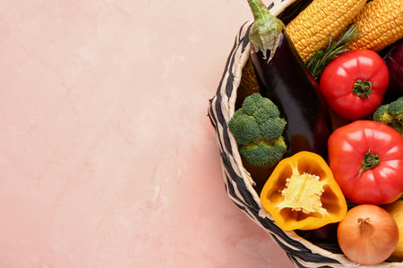 Basket with fresh ripe vegetables on beige background, closeupの写真素材