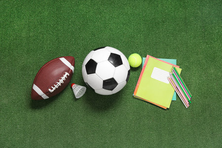 Sport balls with badminton shuttlecock and stationery on color backgroundの写真素材