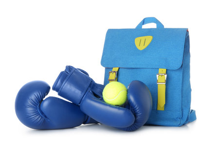 Backpack with boxing gloves and tennis ball isolated on white backgroundの写真素材