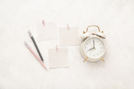 Alarm clock with different stationery on white backgroundの写真素材