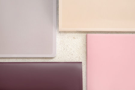 Different colorful notebooks on grunge light background
