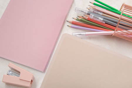Notebooks with pens and pencils holder on white backgroundの写真素材
