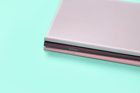 Different colorful notebooks on turquoise background