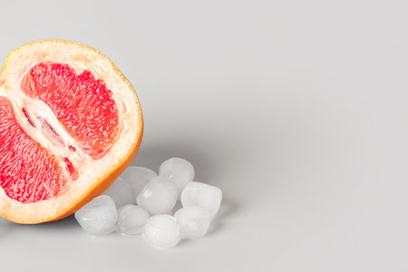 Grapefruit with ice cubes on gray backgroundの写真素材