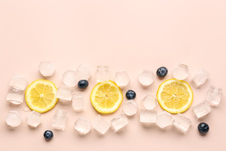 Lime slices with ice cubes and blueberries on beige backgroundの写真素材