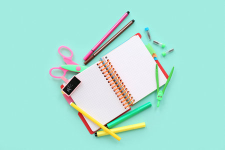 Blank notebook with different stationery on turquoise backgroundの写真素材