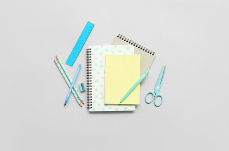 Notebooks and school stationery on gray backgroundの写真素材